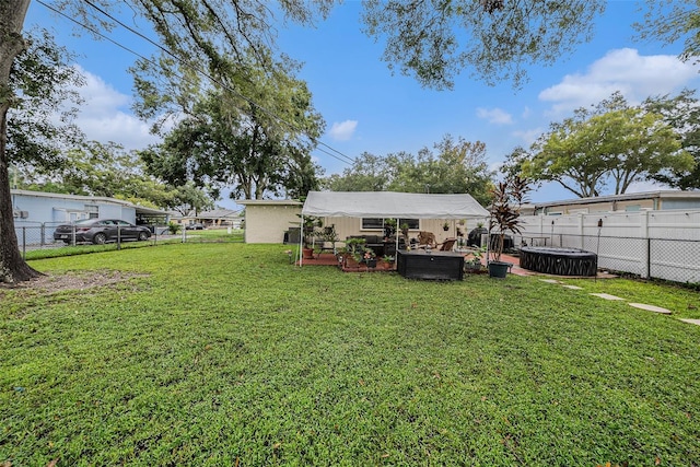 view of yard featuring a jacuzzi, outdoor lounge area, and a patio