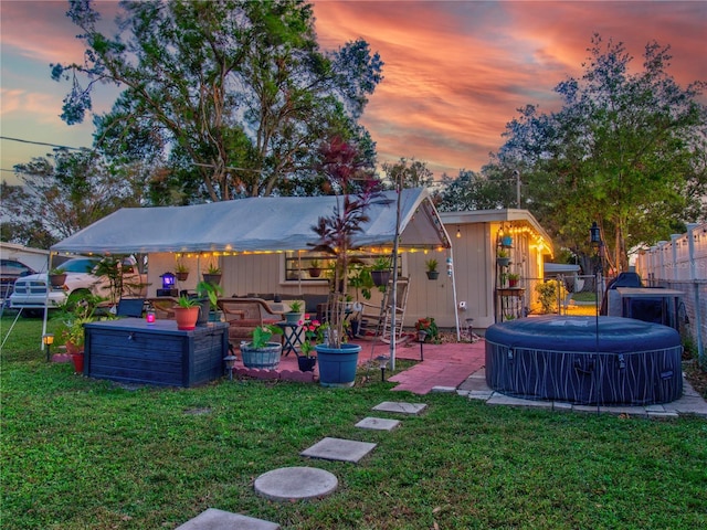 yard at dusk with a patio area