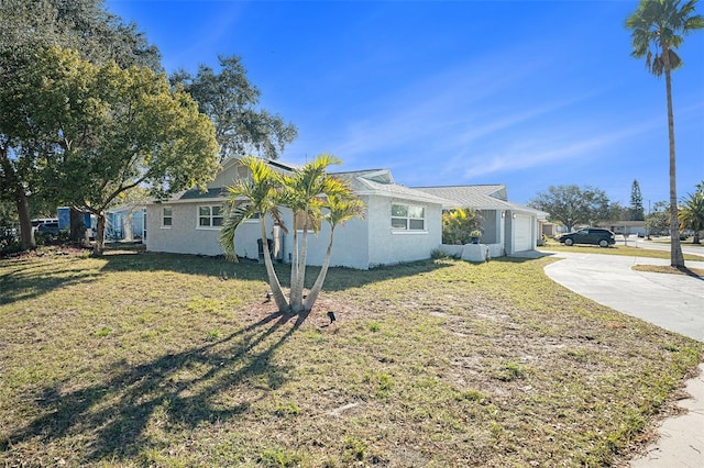 view of property exterior featuring a yard and a garage