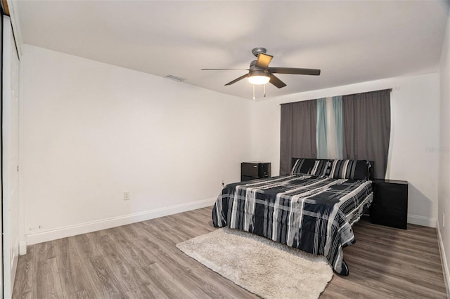 bedroom with ceiling fan and light wood-type flooring