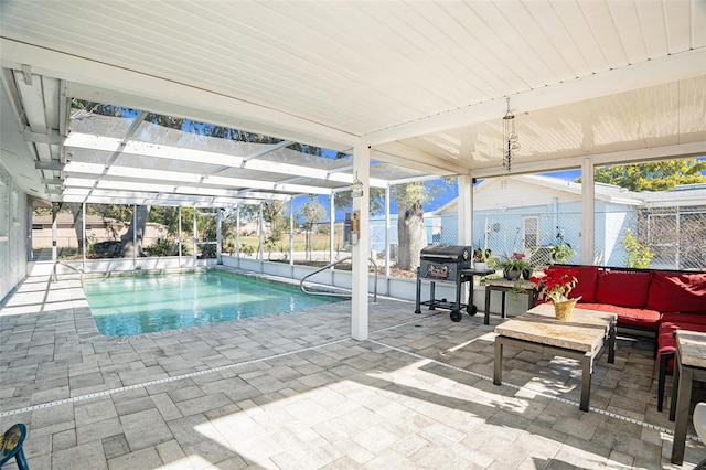 view of pool with a patio area, outdoor lounge area, and glass enclosure