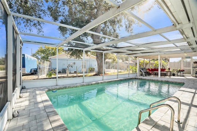 view of pool with outdoor lounge area, a lanai, and a patio area