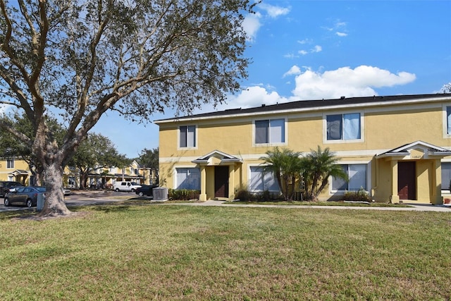 view of front of property featuring central AC and a front lawn