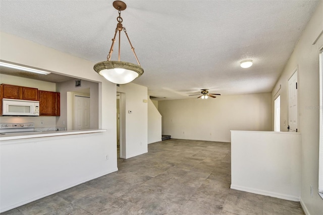 kitchen with ceiling fan, pendant lighting, a textured ceiling, and white appliances