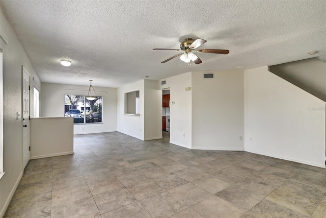 spare room with a textured ceiling and ceiling fan