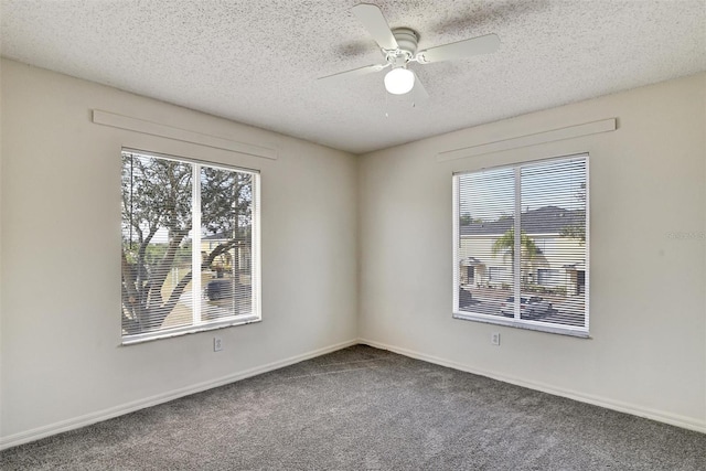 carpeted spare room featuring ceiling fan, a healthy amount of sunlight, and a textured ceiling