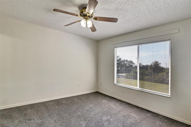 carpeted spare room featuring ceiling fan and a textured ceiling