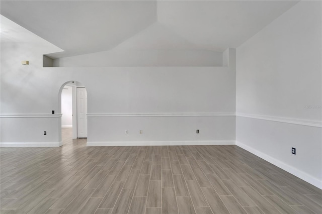 spare room with vaulted ceiling