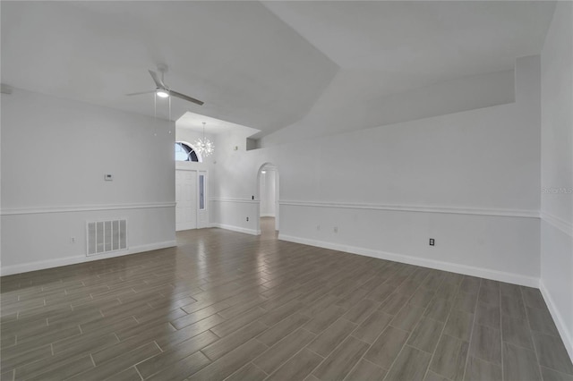 unfurnished living room with lofted ceiling and ceiling fan with notable chandelier