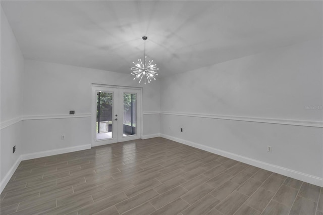 empty room with a chandelier and french doors