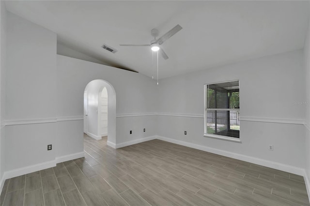 spare room featuring vaulted ceiling and ceiling fan