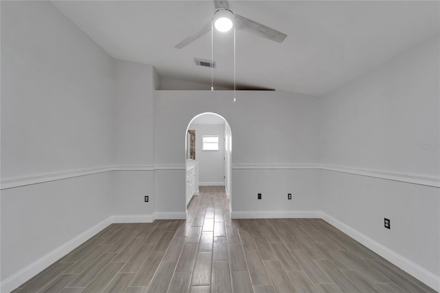 unfurnished dining area with ceiling fan and vaulted ceiling