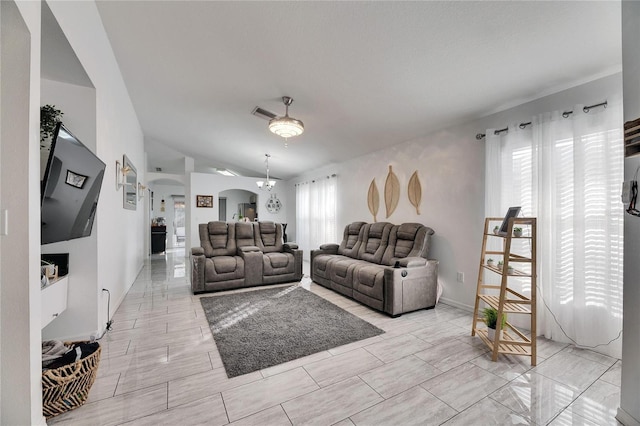 living room featuring lofted ceiling