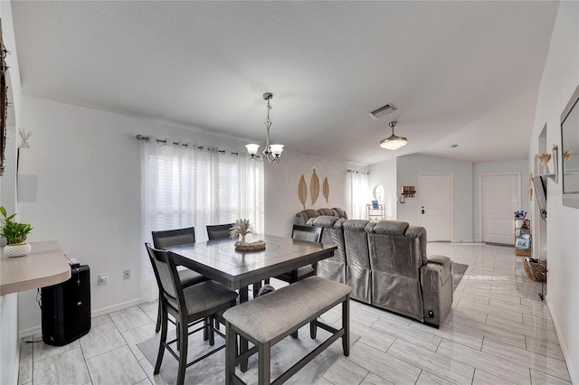 dining space with an inviting chandelier