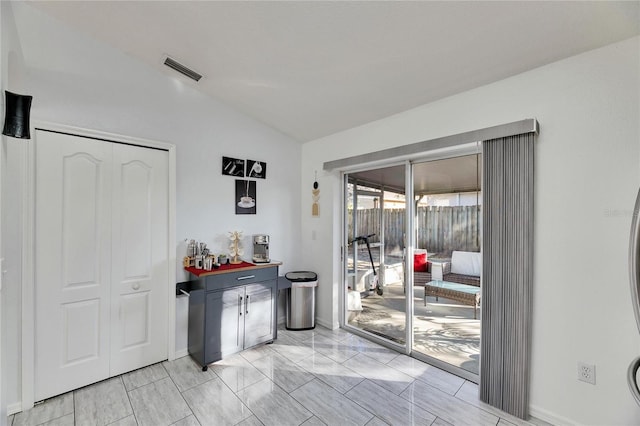 doorway with lofted ceiling