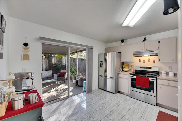 kitchen with appliances with stainless steel finishes and a textured ceiling