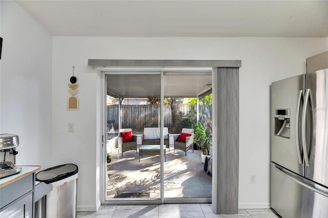 doorway with light tile patterned floors