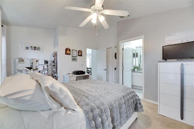 carpeted bedroom featuring ceiling fan and ensuite bath