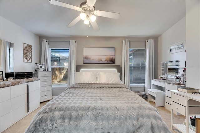 bedroom featuring light carpet and ceiling fan