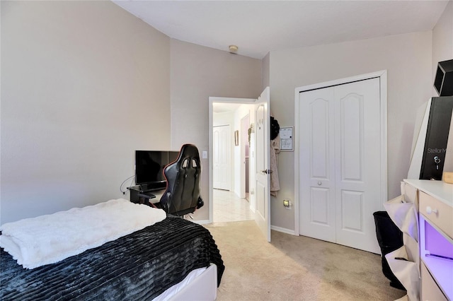 bedroom featuring light carpet and a closet