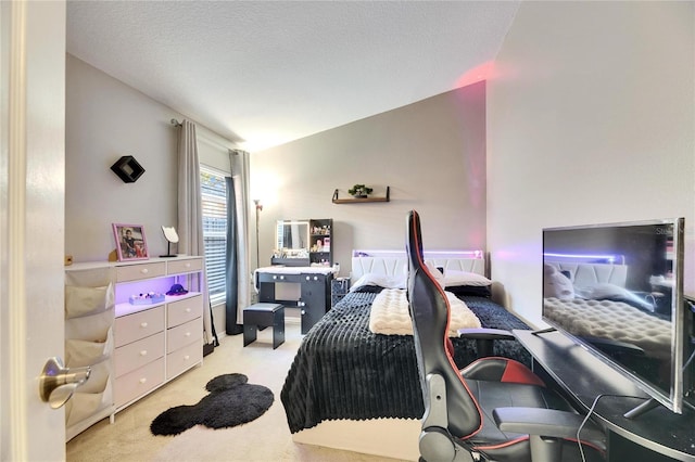 carpeted bedroom with lofted ceiling and a textured ceiling