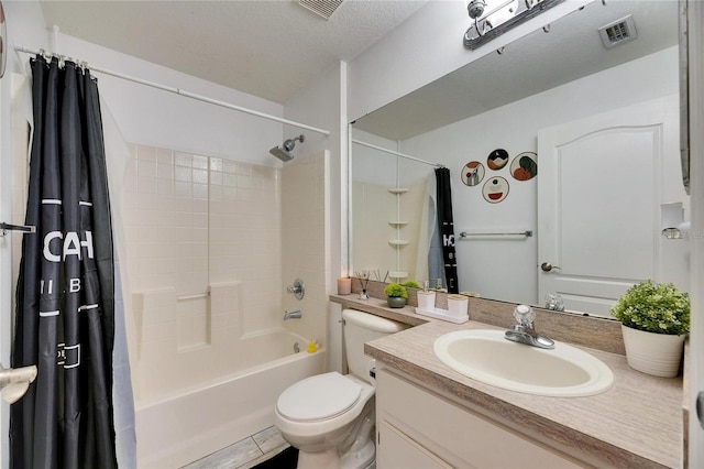 full bathroom with tile patterned floors, toilet, a textured ceiling, vanity, and shower / bath combo with shower curtain