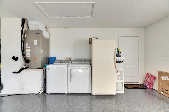 washroom featuring washing machine and dryer and heating unit