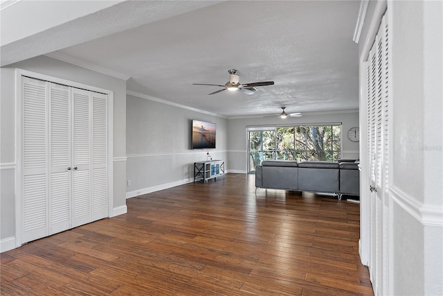 interior space featuring ornamental molding, a textured ceiling, and dark hardwood / wood-style flooring