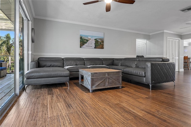 living room with crown molding, ceiling fan, and dark hardwood / wood-style floors