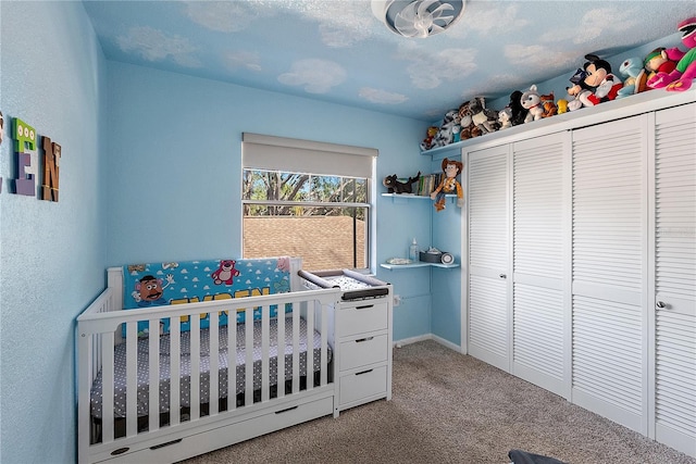 carpeted bedroom with a nursery area and a closet