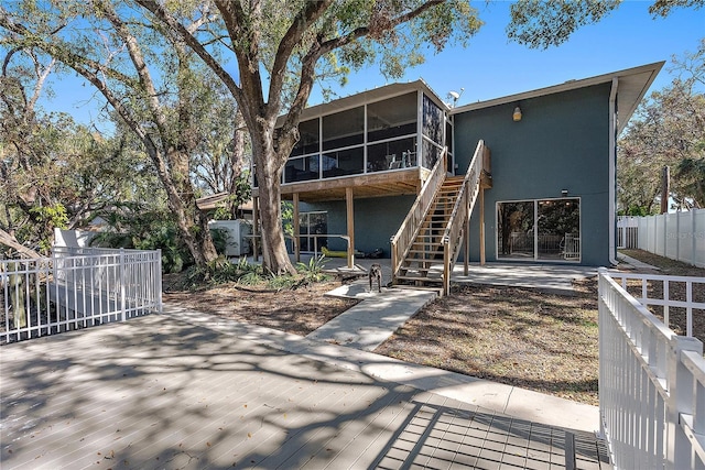 back of house featuring a sunroom and a patio