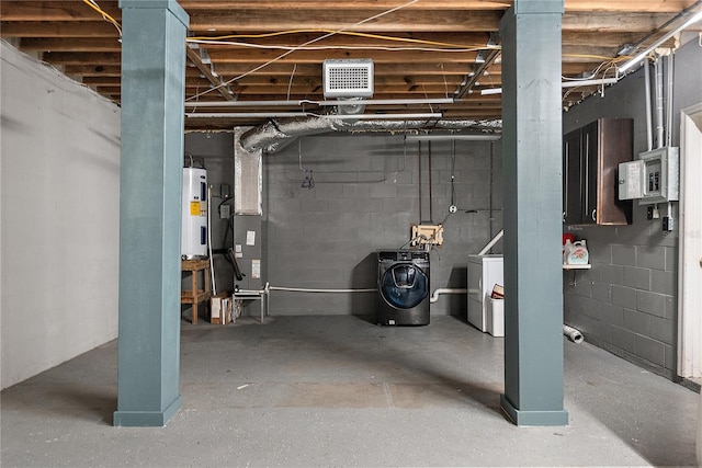 basement with electric water heater, washing machine and dryer, and heating unit