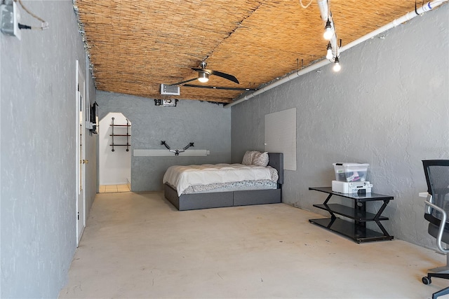 unfurnished bedroom with concrete floors and ceiling fan