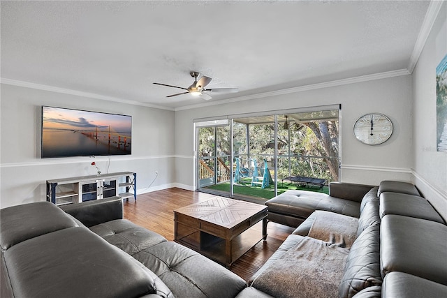 living room featuring hardwood / wood-style flooring, ceiling fan, and crown molding