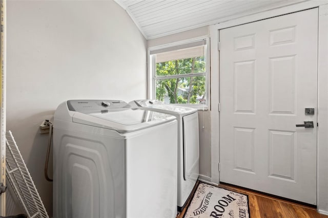 laundry area with wood-type flooring and washer and clothes dryer