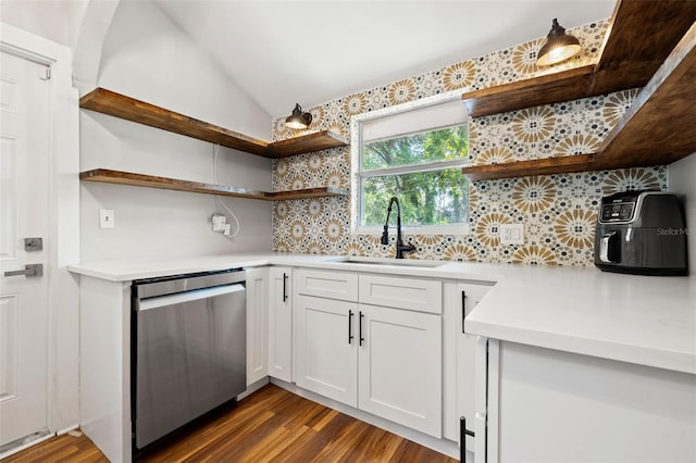 kitchen with sink, white cabinetry, backsplash, vaulted ceiling, and stainless steel dishwasher