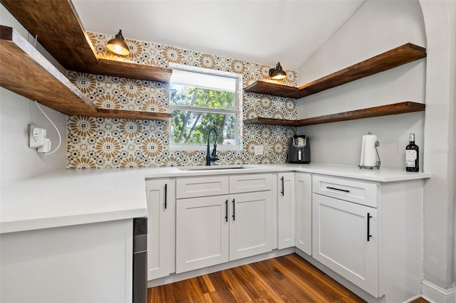 kitchen with sink, white cabinets, dark hardwood / wood-style floors, and decorative backsplash