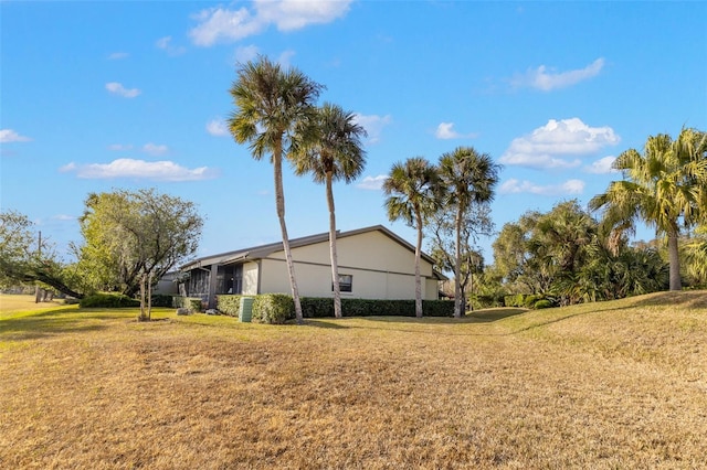 view of side of home featuring a lawn