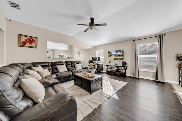 living room with dark hardwood / wood-style flooring, a textured ceiling, vaulted ceiling, and ceiling fan