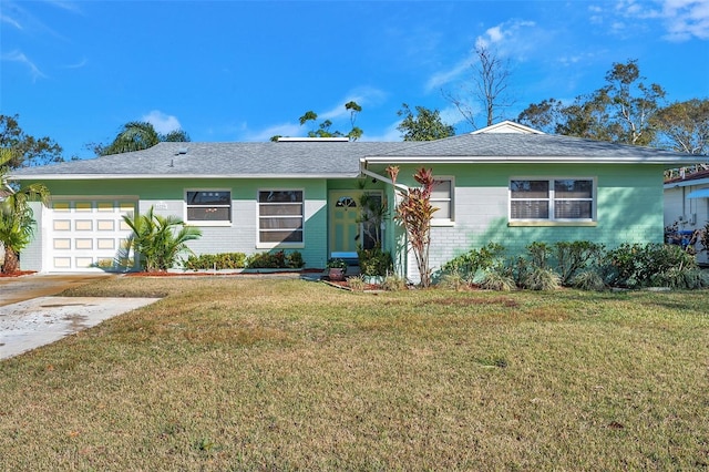 single story home with a garage and a front lawn