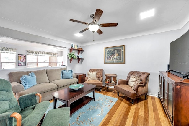 living room featuring ceiling fan and light wood-type flooring