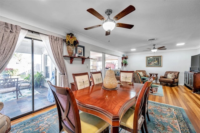 dining area with ceiling fan, plenty of natural light, and hardwood / wood-style floors