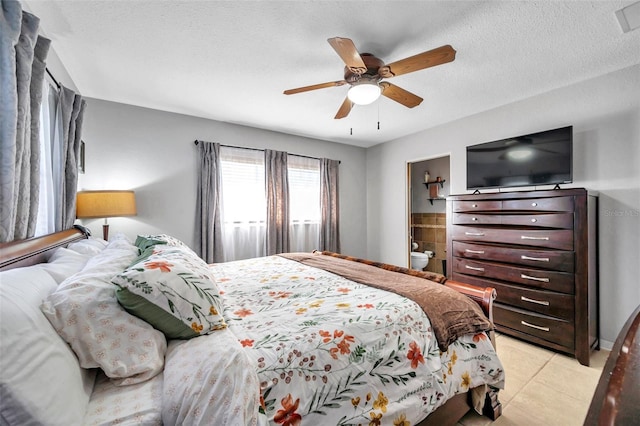 tiled bedroom featuring a textured ceiling and ceiling fan