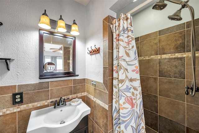 bathroom with vanity, tile walls, and a shower with curtain