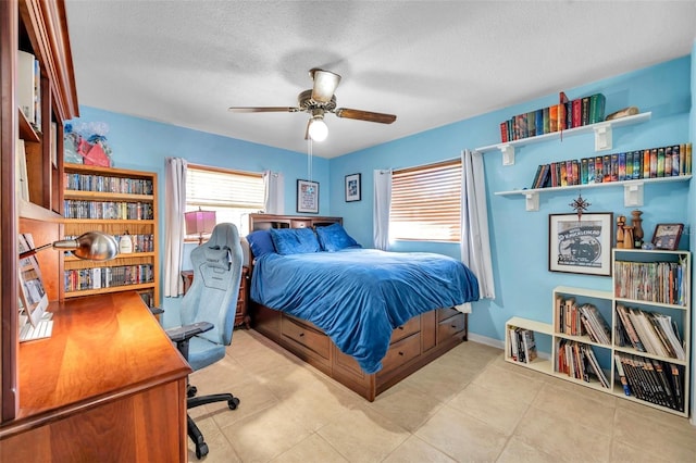 tiled bedroom with a textured ceiling and ceiling fan