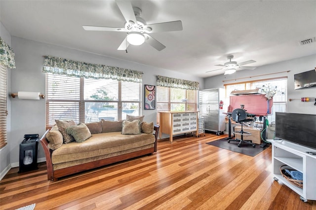 living room with ceiling fan and wood-type flooring