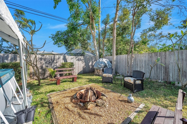 view of yard featuring an outdoor fire pit