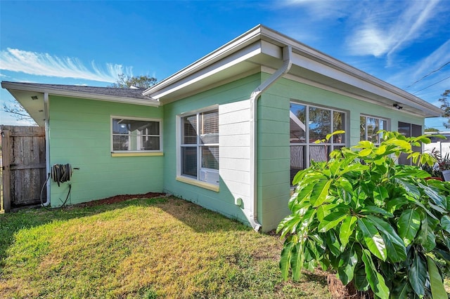 view of side of home with a lawn