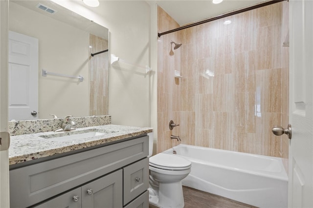 full bathroom featuring shower / tub combination, wood-type flooring, toilet, and vanity