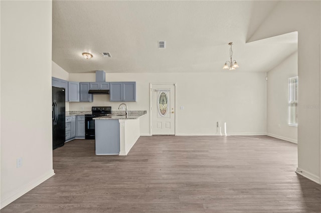 kitchen with decorative light fixtures, sink, dark wood-type flooring, and black appliances